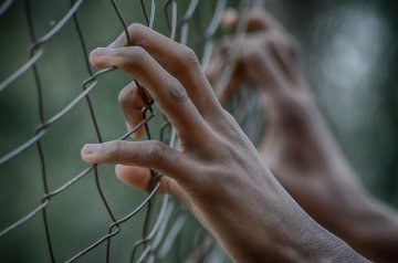Hands in fence - Human rights generic