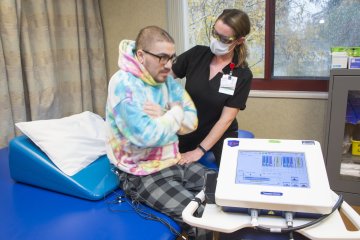 Patient assisted in sitting up at Sunnyview Rehabilitation Hospital