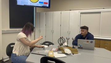 Student at laptop in classroom learning Physics.