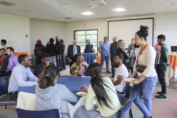 Students mingle at the International Welcome Reception at Utica University in 2024.